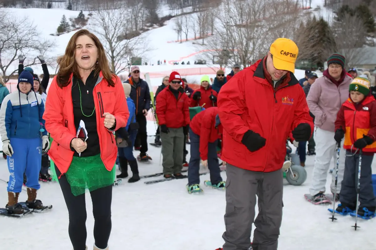 Volunteers and participants cheering at a winter event
